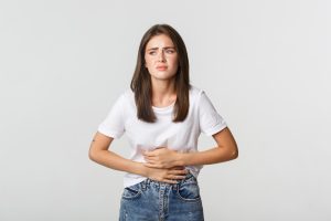 Konsumsi Obat Pereda Nyeri Haid: Boleh Nggak Sih? 1 woman having stomach ache bending with hands belly discomfort from menstrual cramps